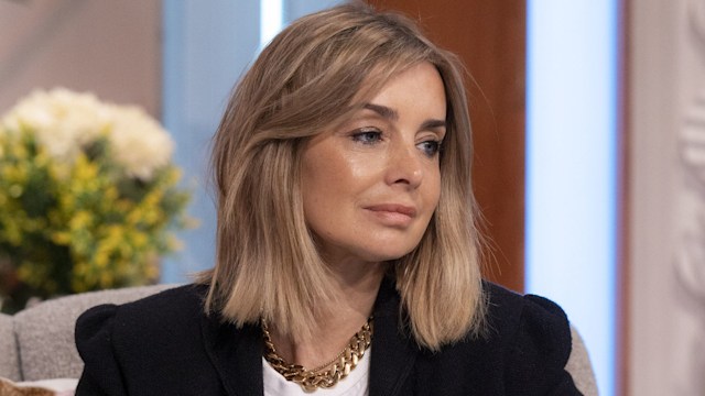 Louise Redknapp looking sad in a black blazer and white shirt