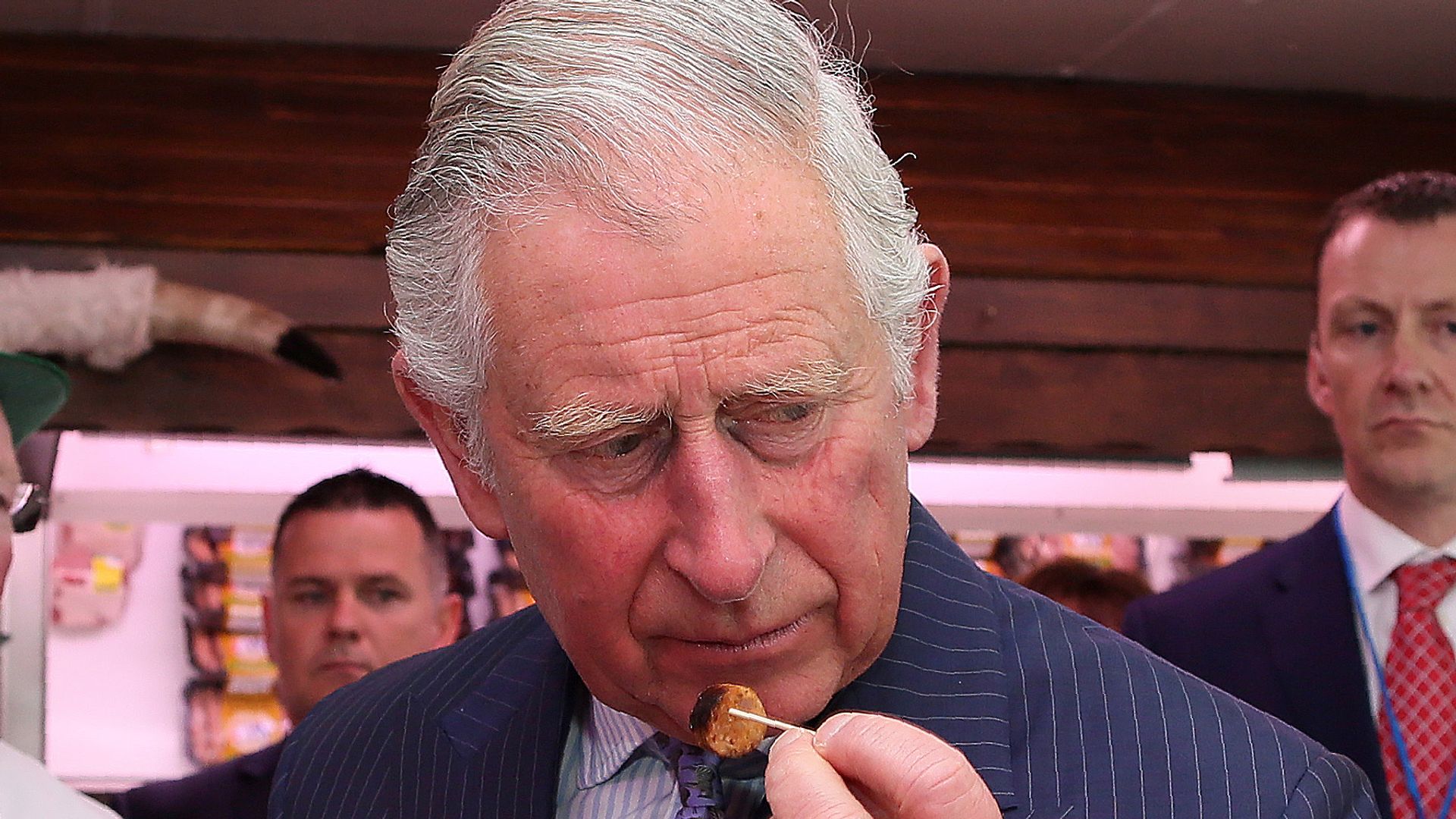 Prince Charles, Prince of Wales (R) and Camilla, Duchess of Cornwall try a selection of sausages inside McGettigans Butchers store on May 25, 2016 in Donegal, Ireland.  The royal couple are on a one day visit to Ireland having spent two days across the border in Northern Ireland. It is their first trip to Donegal