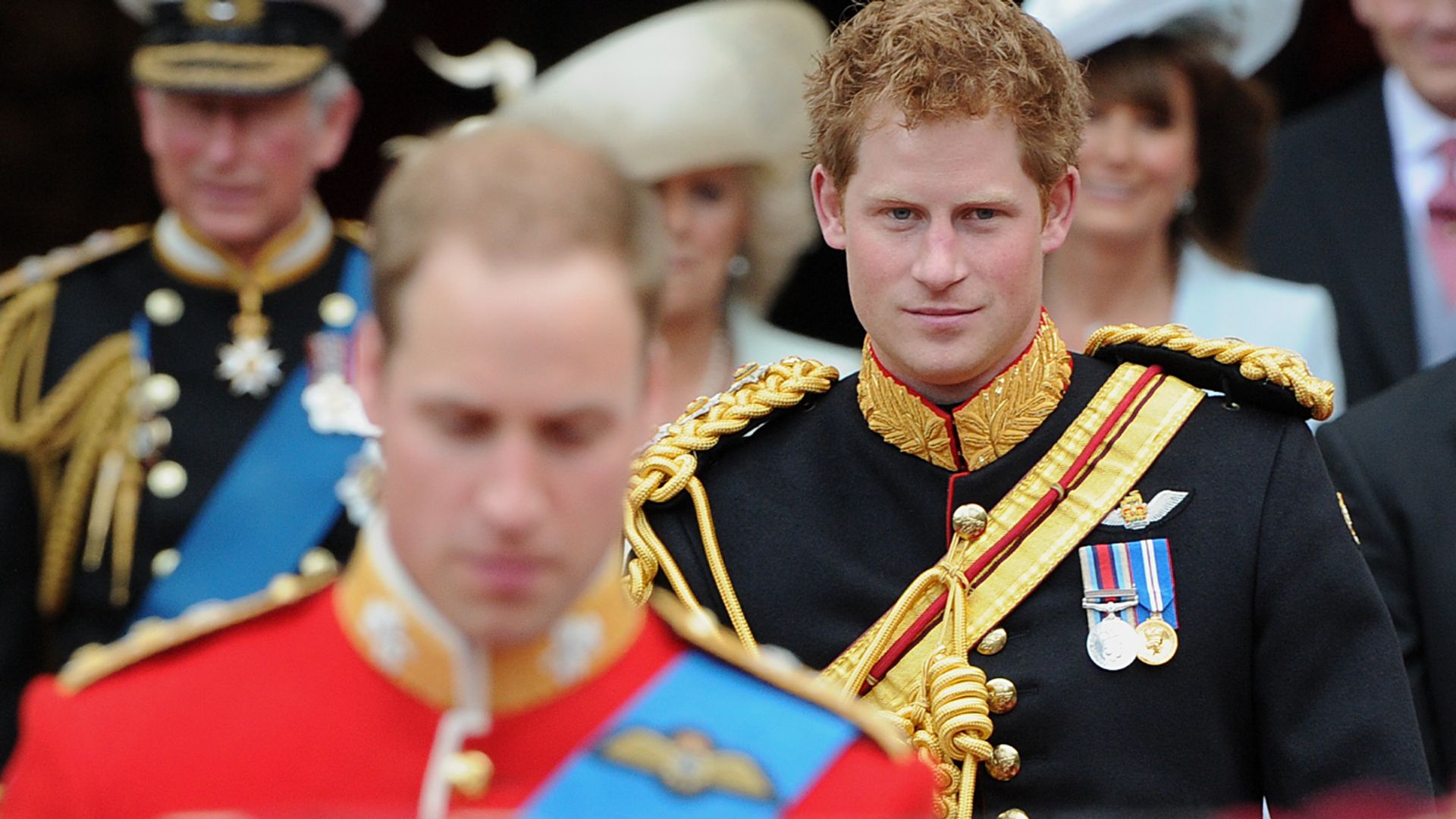 Prince Harry walking behind Prince William at his wedding