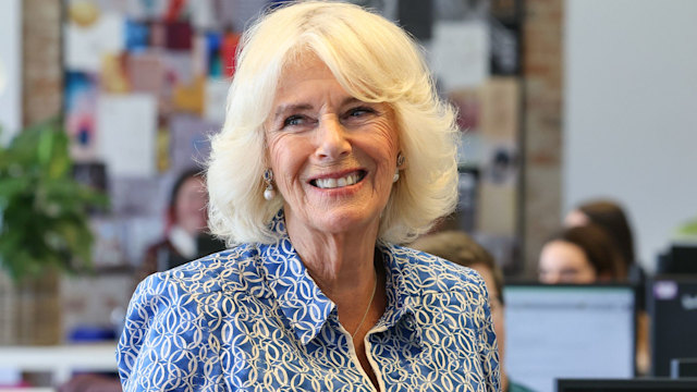 Queen Camilla smiling blue dress