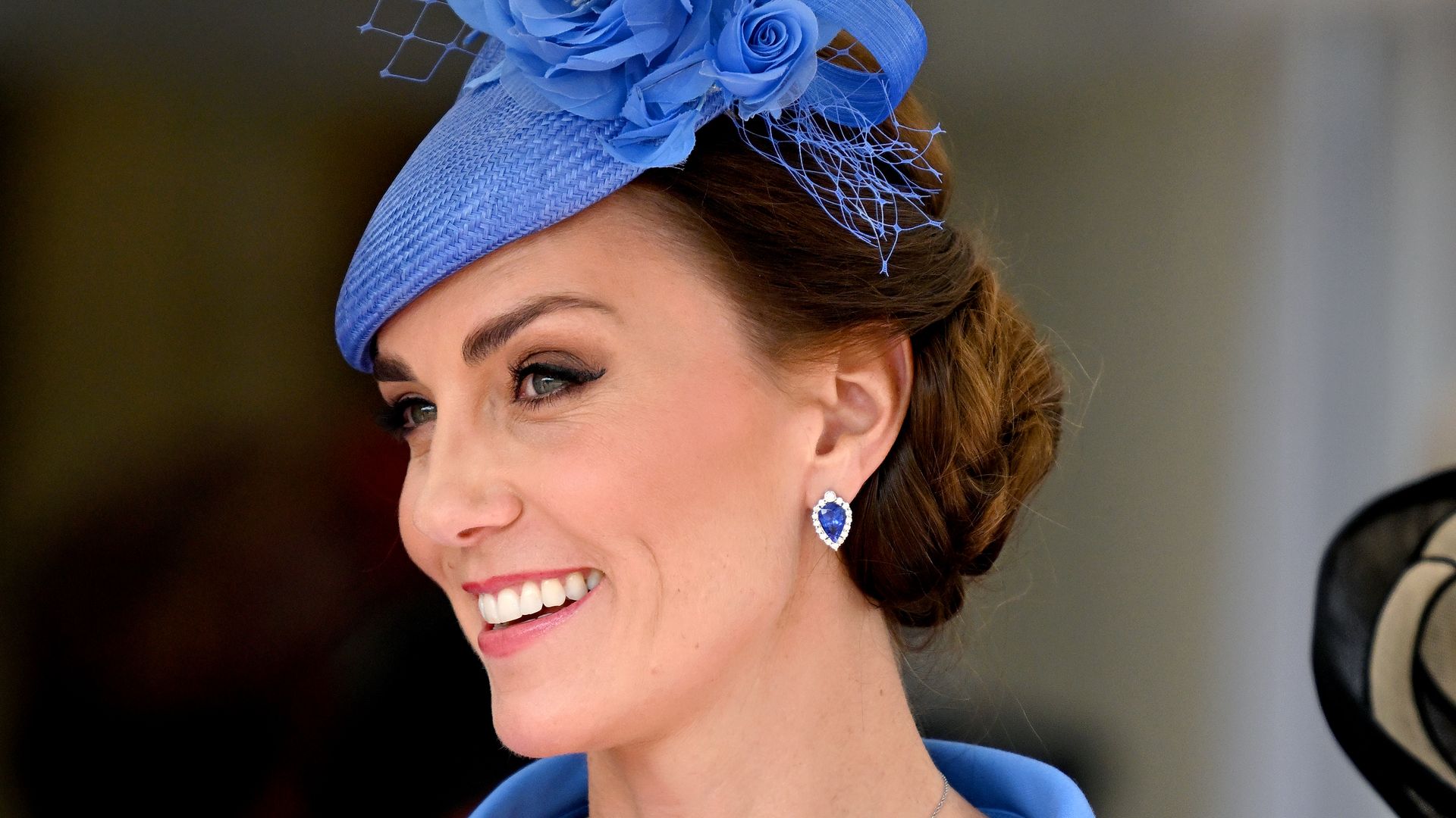 Kate Middleton smiling in blue hat and dress
