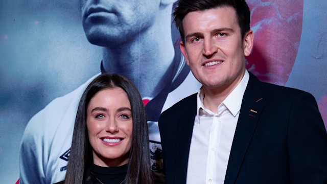 Harry Maguire in a suit with his wife Fern Hawkins dressed in black