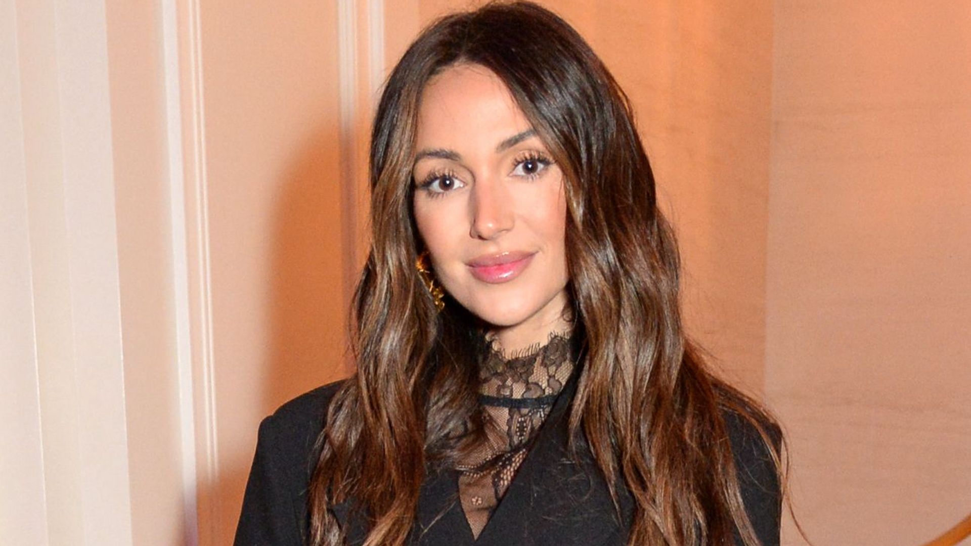 Michelle Keegan wearing all black outfit standing and posing for a photo while attending the Glamour Women of the Year Awards