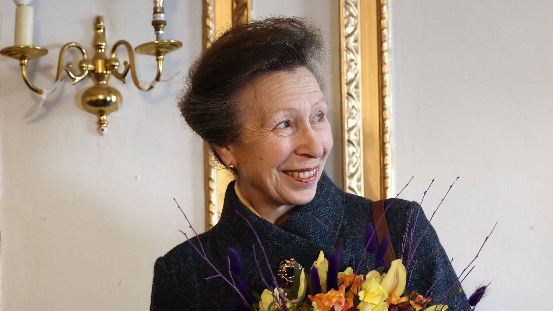 Princess Anne, Princess Royal smiles after receiving flowers during her visit to knife crime community group 'Off The Streets' on February 16, 2024 in Wellingborough, England.