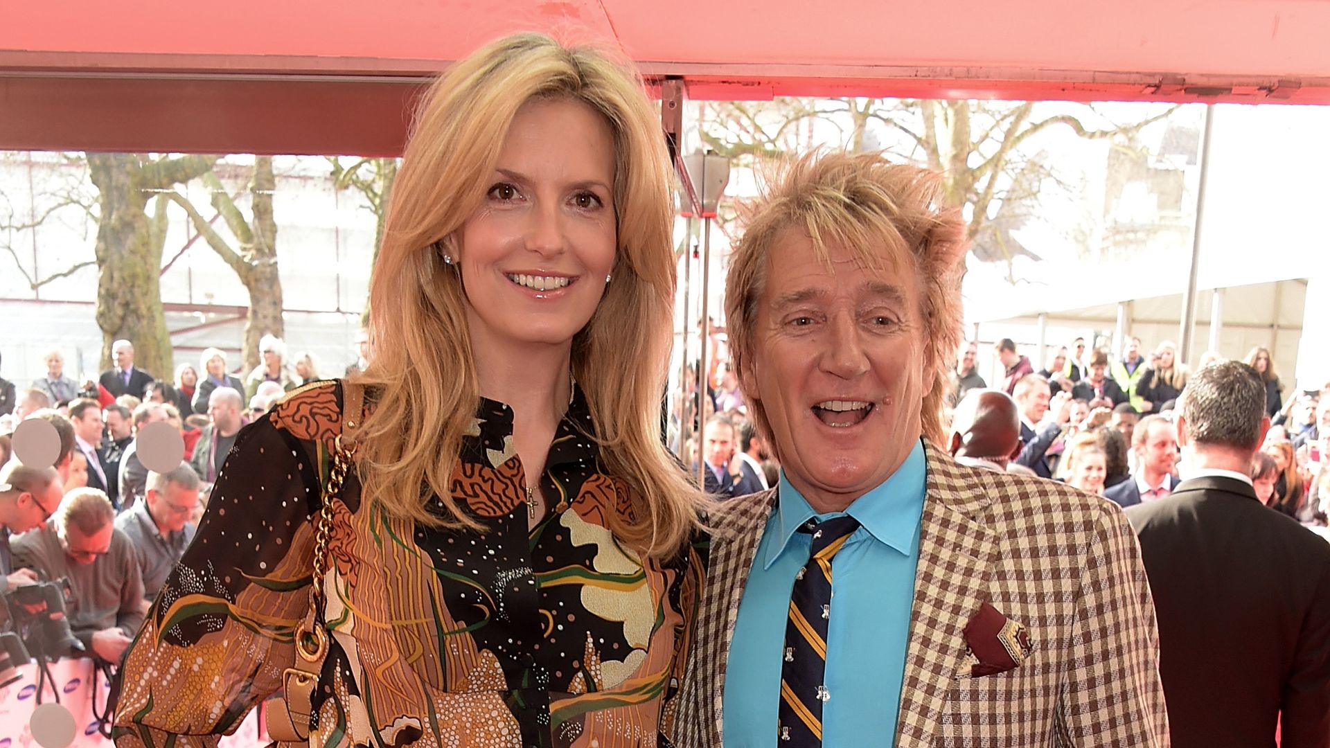 Penny Lancaster and Rod Stewart both wearing beige outfits