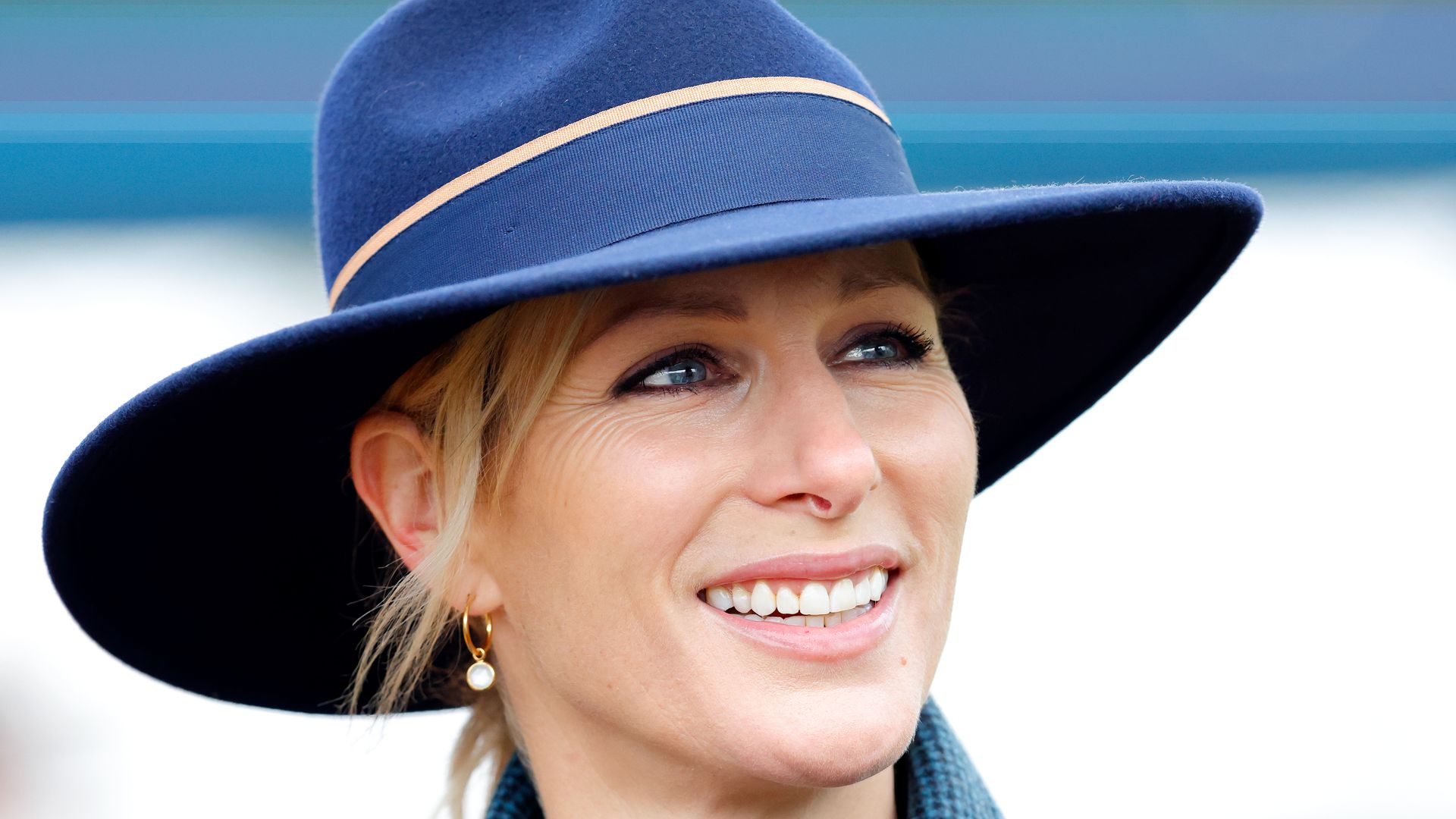 Zara Tindall in blue coat and hat