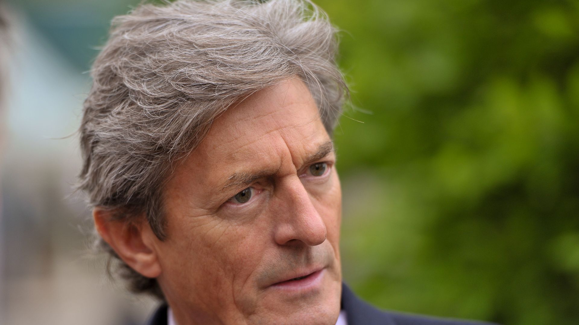 Nigel Havers looking concerned in a suit