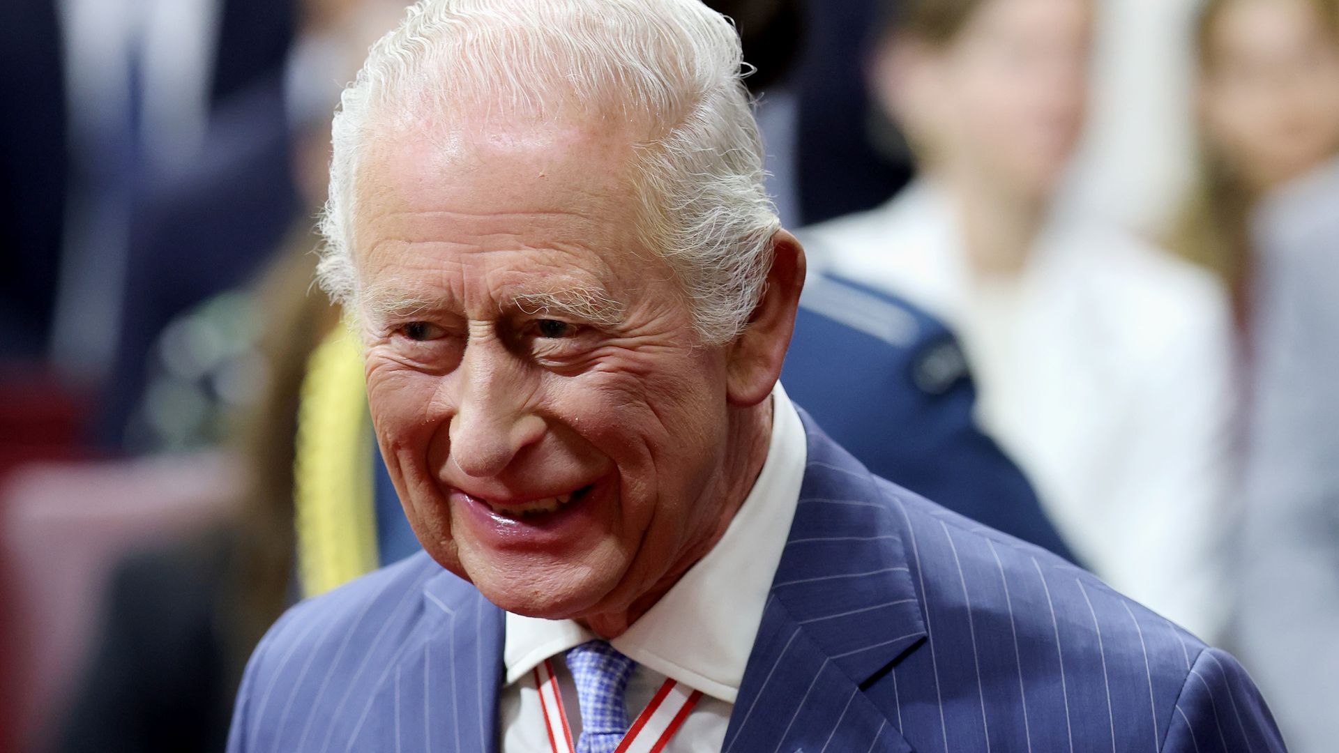 King Charles smiling wearing medals in Senate