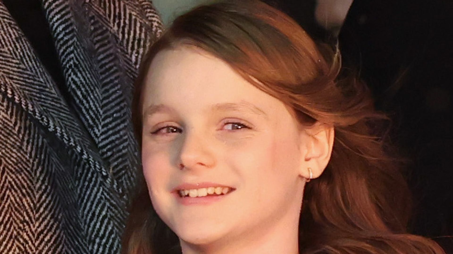 Princess Gabriella of Monaco smiling in navy coat