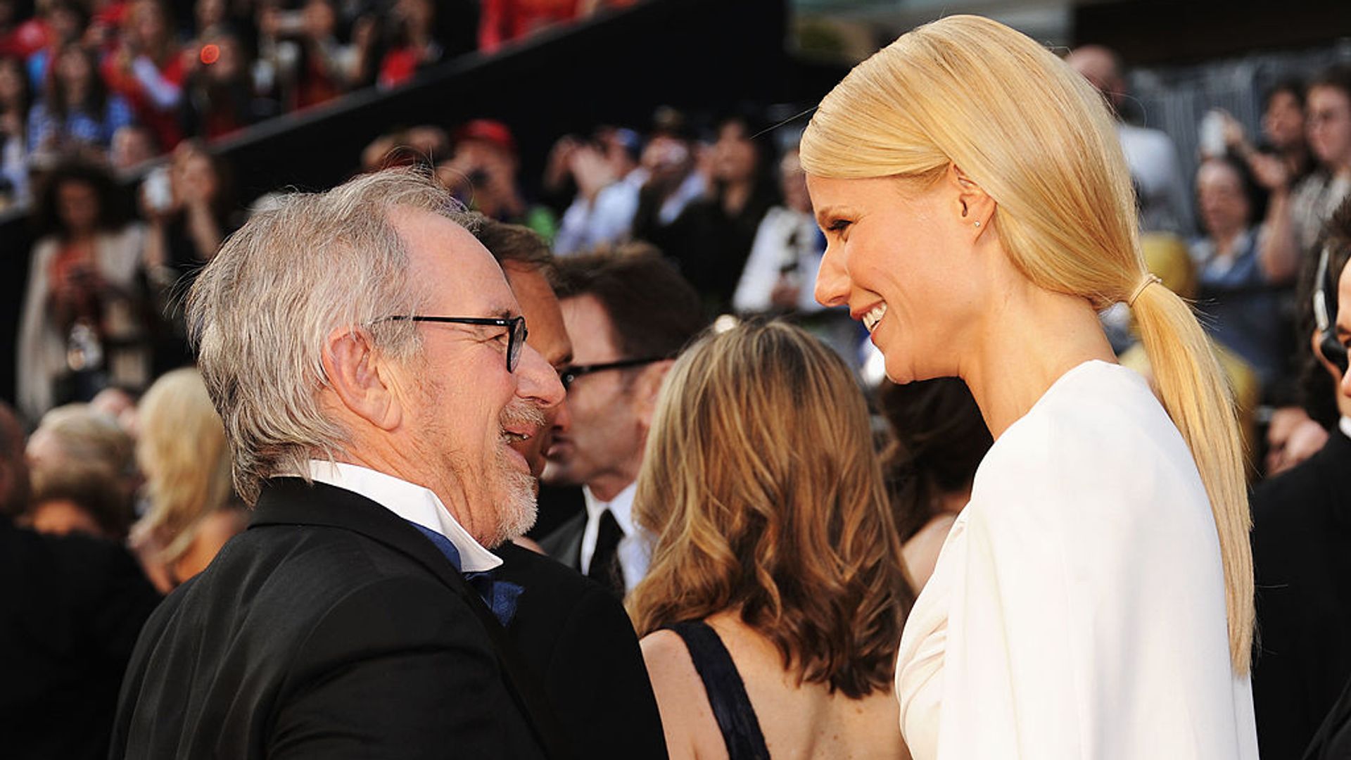 Gwyneth Paltrow and Steven Spielberg smiling at each other. 