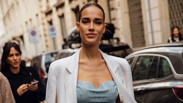 Woman wearing dress with white jacket
