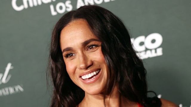 woman smiling in red dress at gala