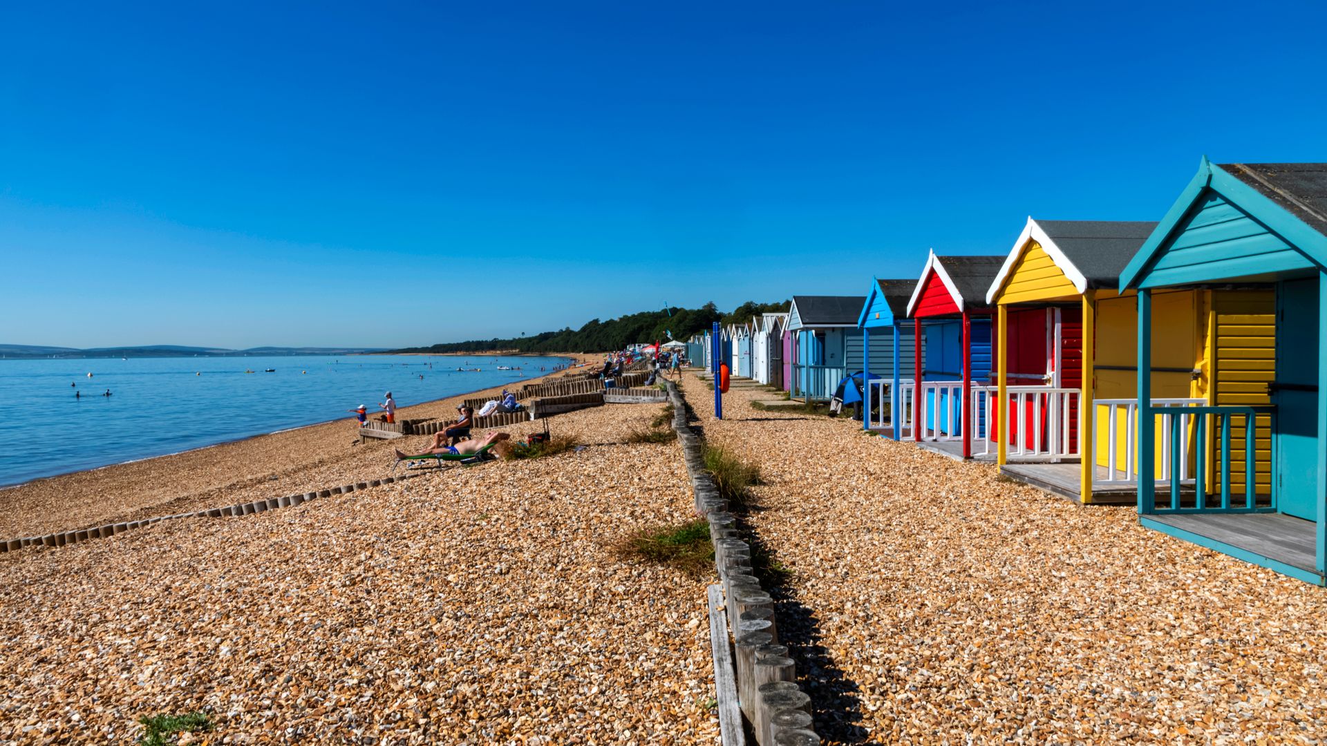 England, Hampshire, New Forest, Calshot, Calshot Beach, Colourful Beach Huts. (Photo by: Dukas/Universal Images Group via Getty Images)