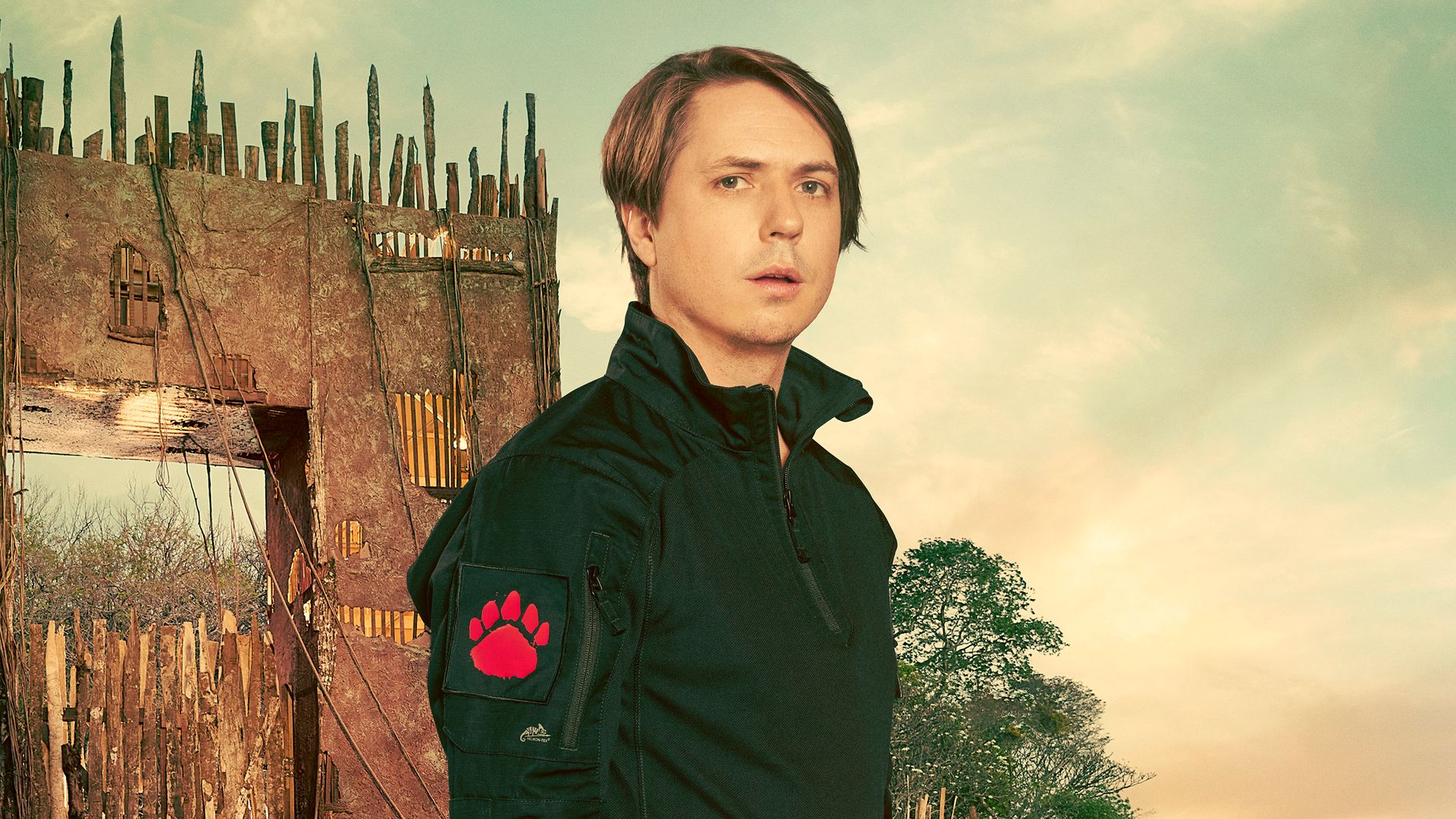 man standing in front of gate