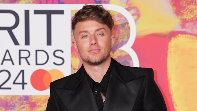 A close-up photo of Roman Kemp on the red carpet at the Brit Wards 2024 wearing a black suit