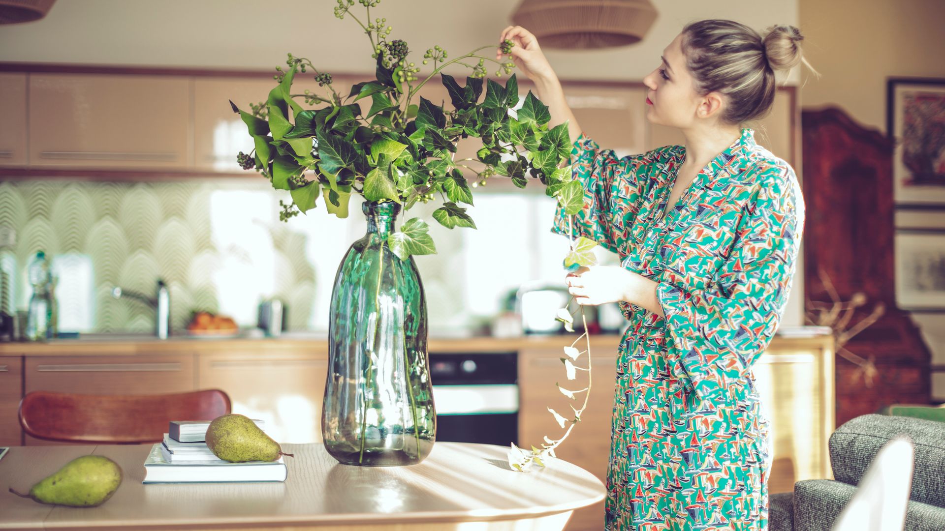 Young woman at home tending to flowers