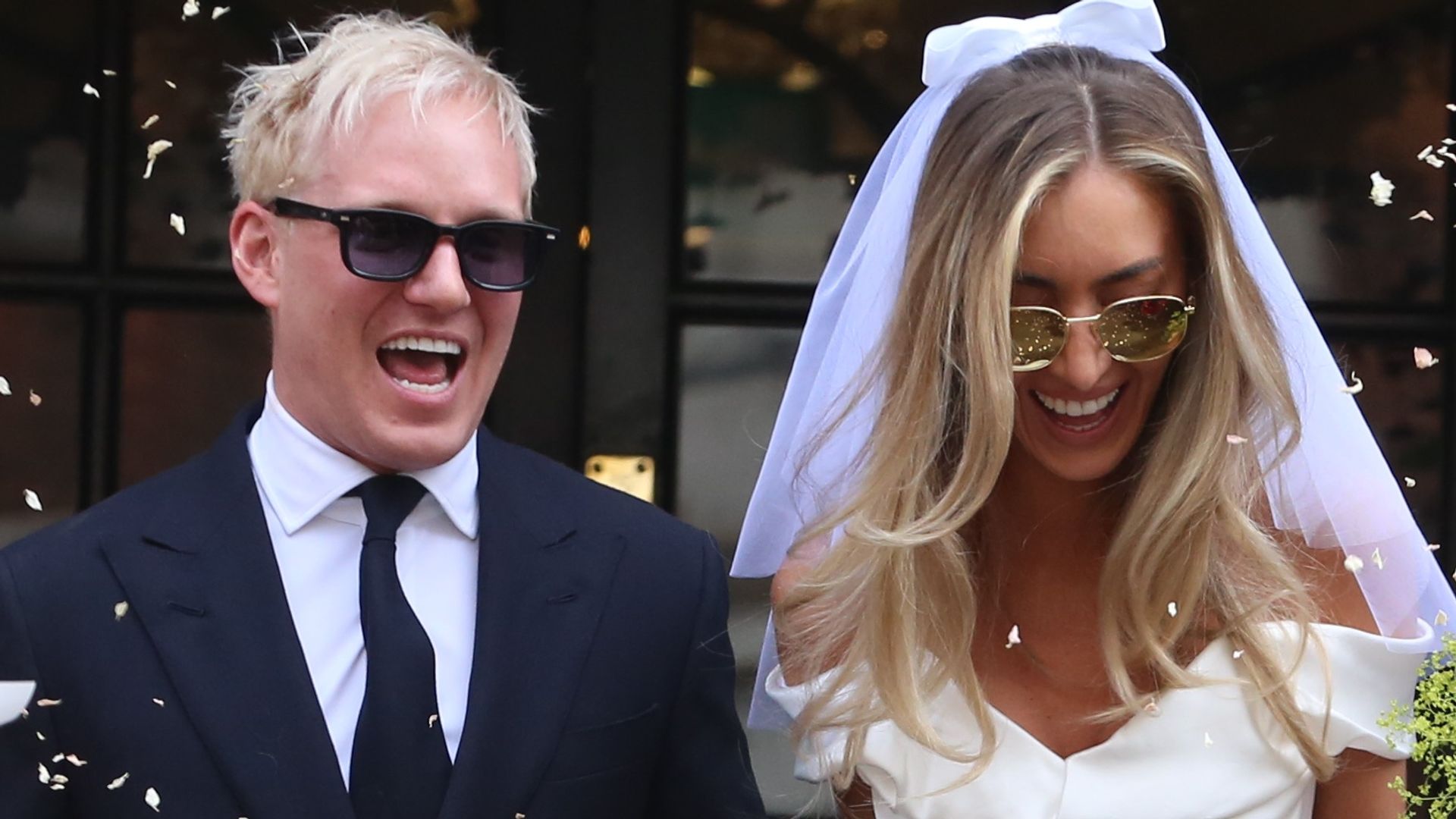 Newlyweds Jamie Laing and Sophie Habboo being showered with confetti at their Chelsea wedding