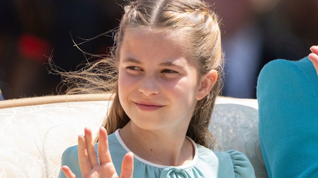 Princess Charlotte waving in a blue dress