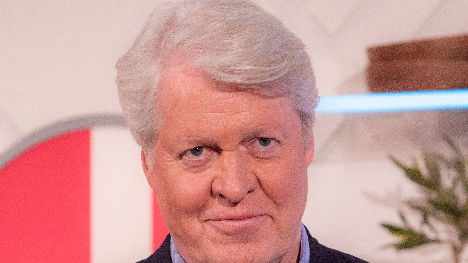 Charles Spencer in a suit without a tie