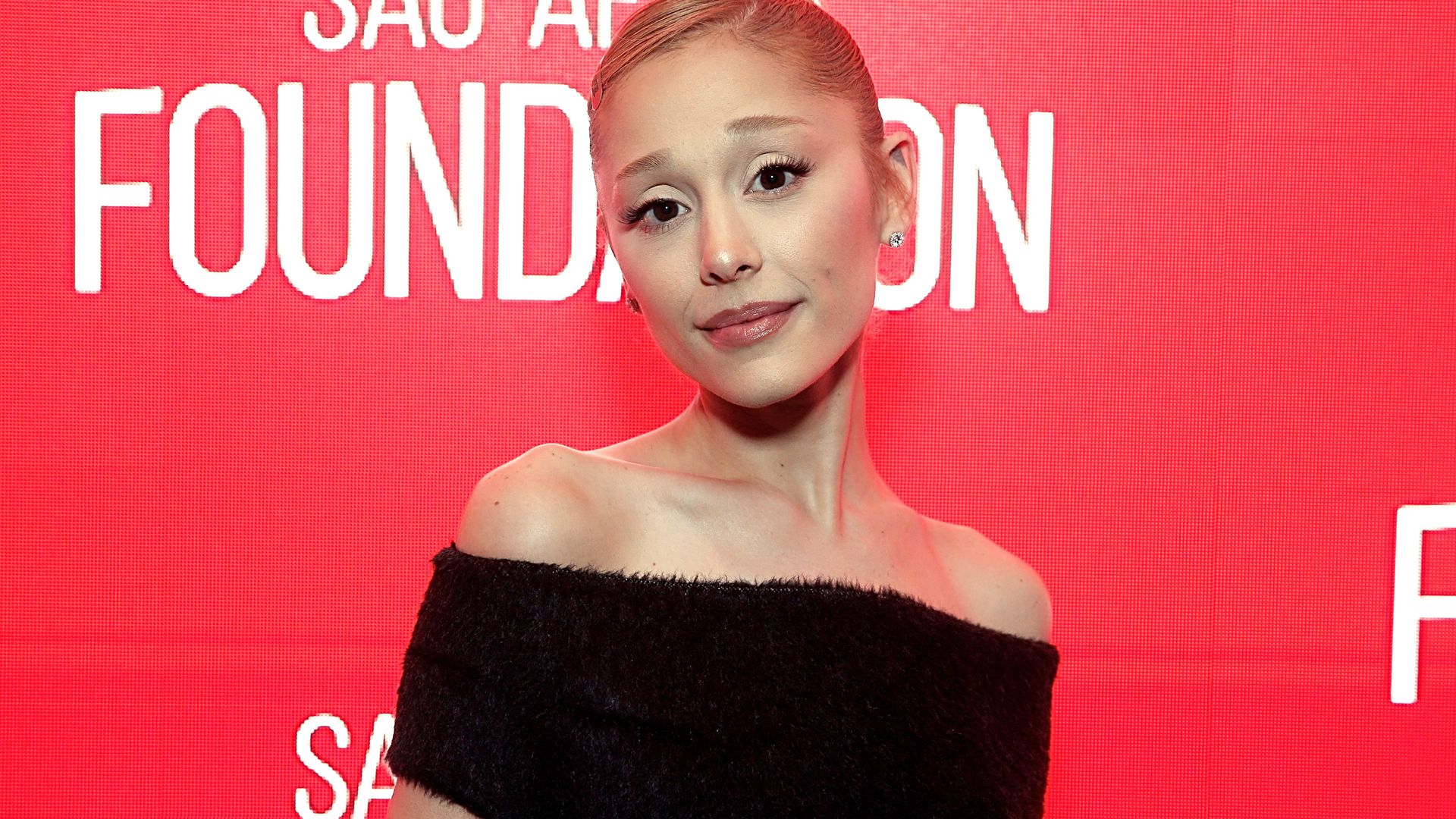 Ariana Grande looks nearly unrecognizable as she ditches Glinda pink for vampy black dress