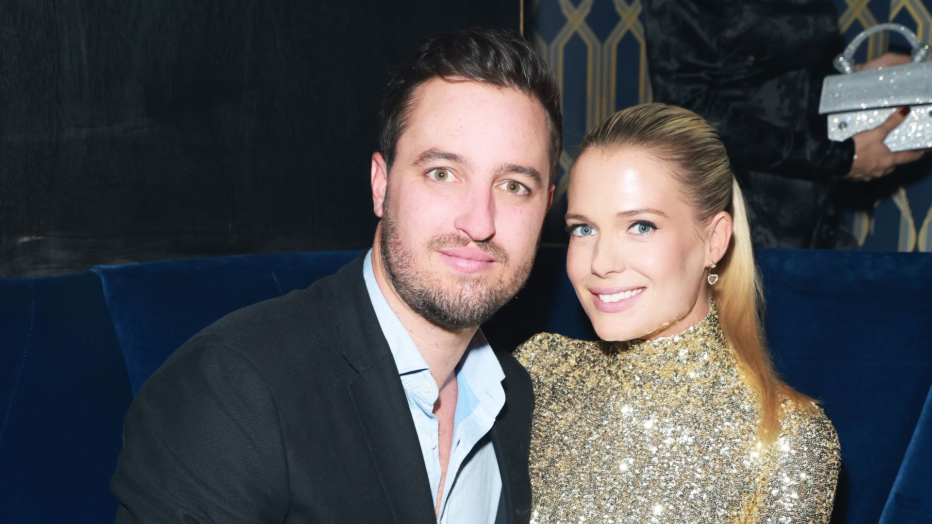 Channing Millerd and Lady Eliza Spencer sitting on a blue velvet sofa