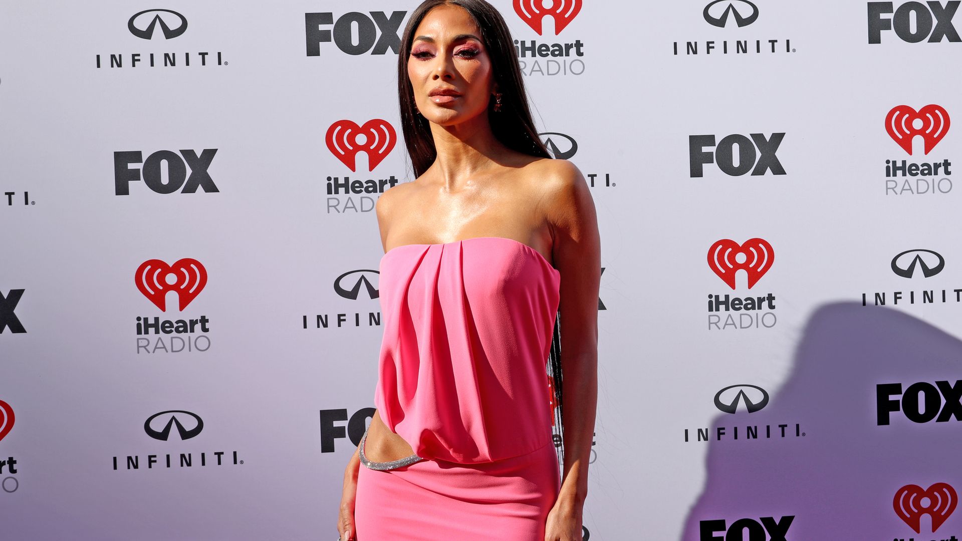 Nicole Scherzinger stuns in strapless cut-out gown in the boldest colour