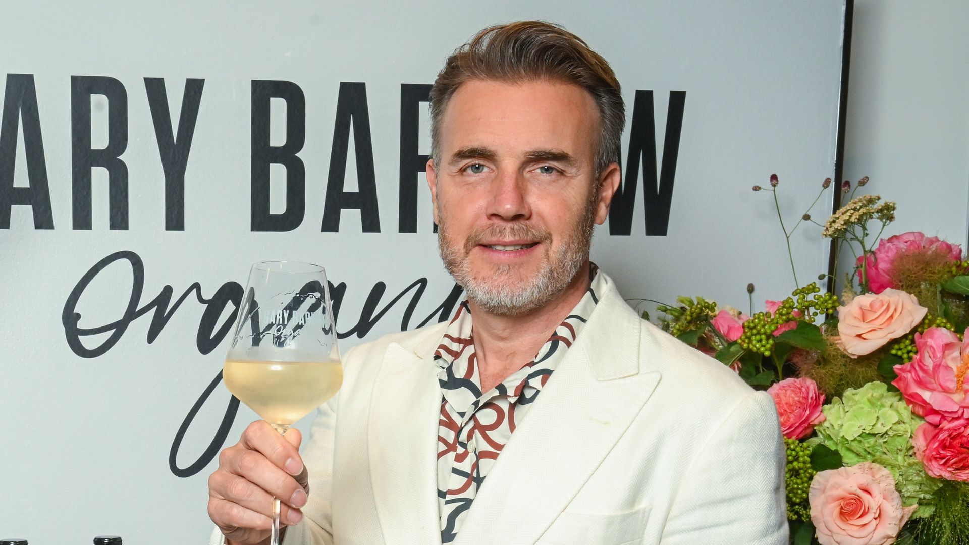 Gary Barlow raising a glass of wine at the launch of his wine brand