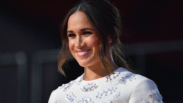 Meghan Markle in a white dress covered with flowers