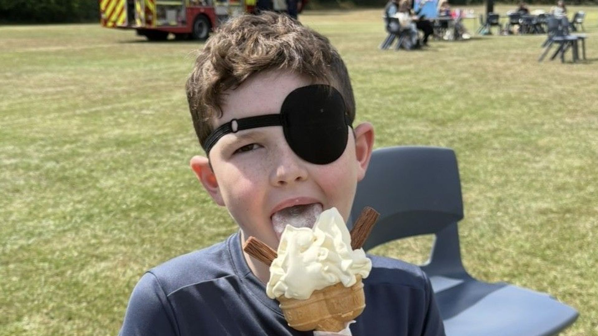 young boy eating ice cream with eye patch