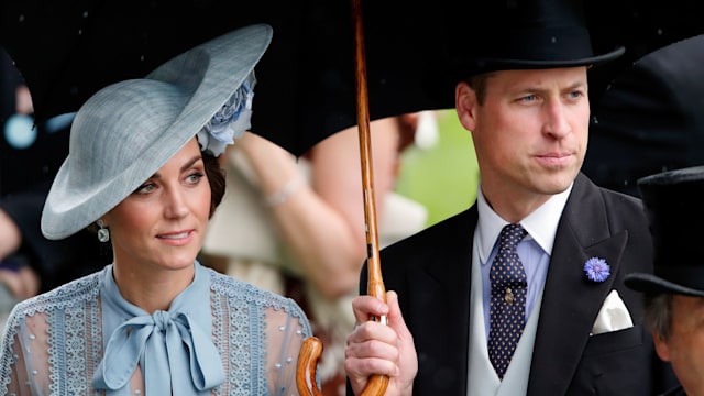 Princess Kate and Prince William shelter under an umbrella as they attend day one of Royal Ascot at Ascot Racecourse on June 18, 2019 in Ascot, England.