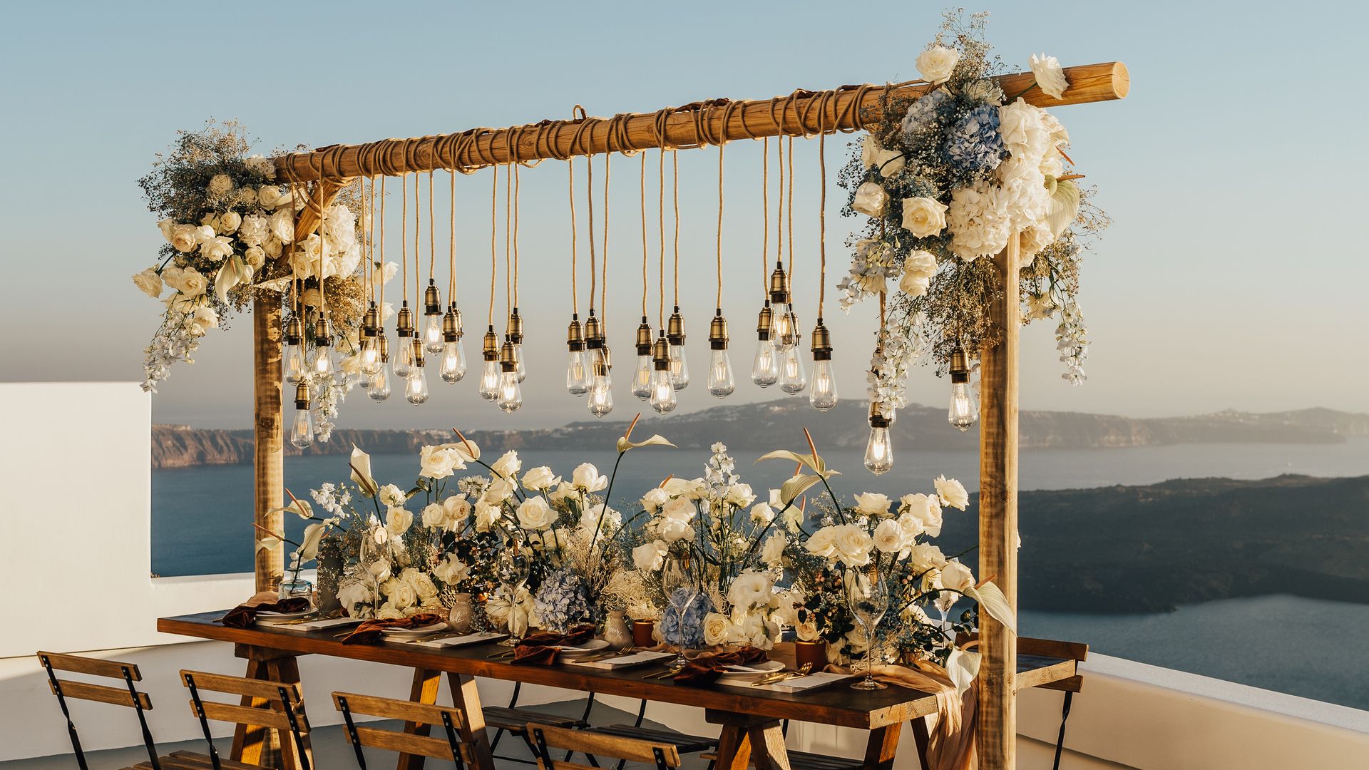 Wooden wedding table on a rooftop in Santorini