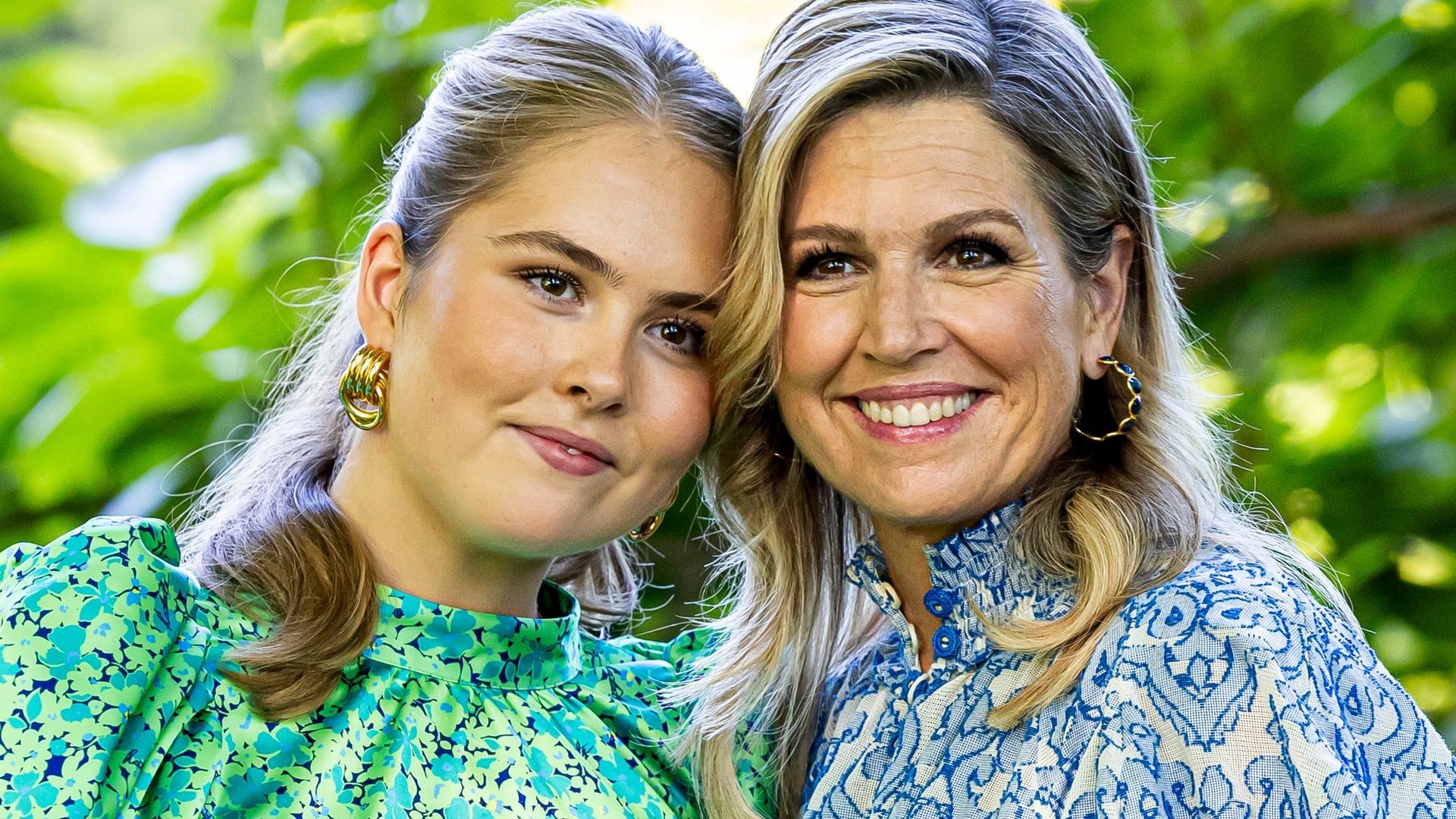 Queen Maxima in a blue dress with daughter Princess Catharina Amalia in a green top