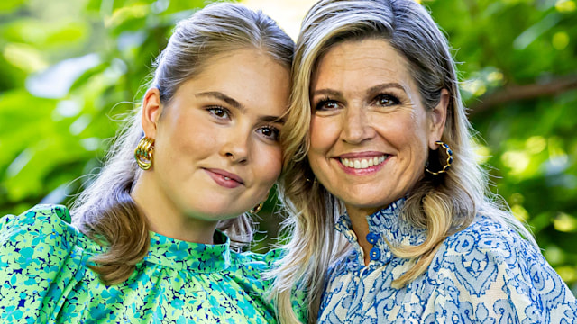 Queen Maxima in a blue dress with daughter Princess Catharina Amalia in a green top