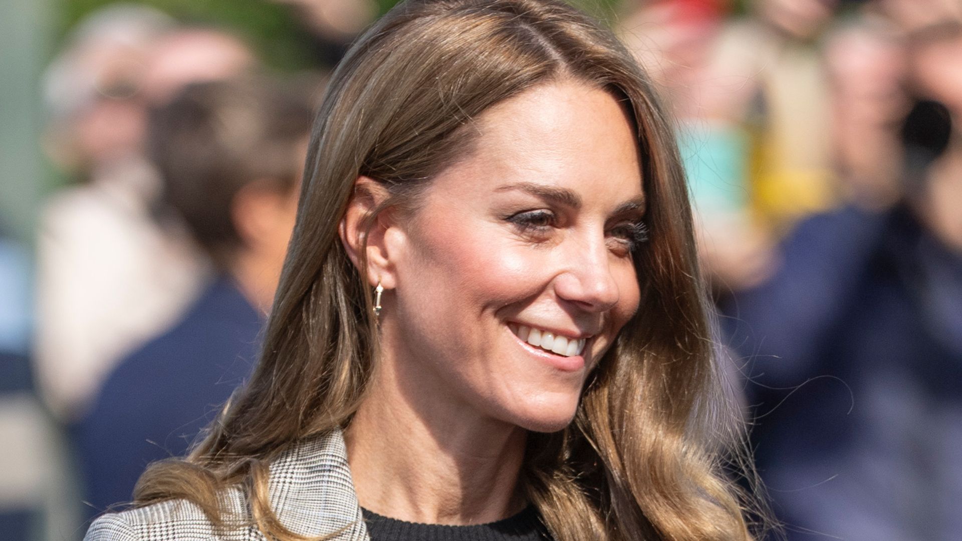 Catherine, Princess of Wales smiling in grey check suit