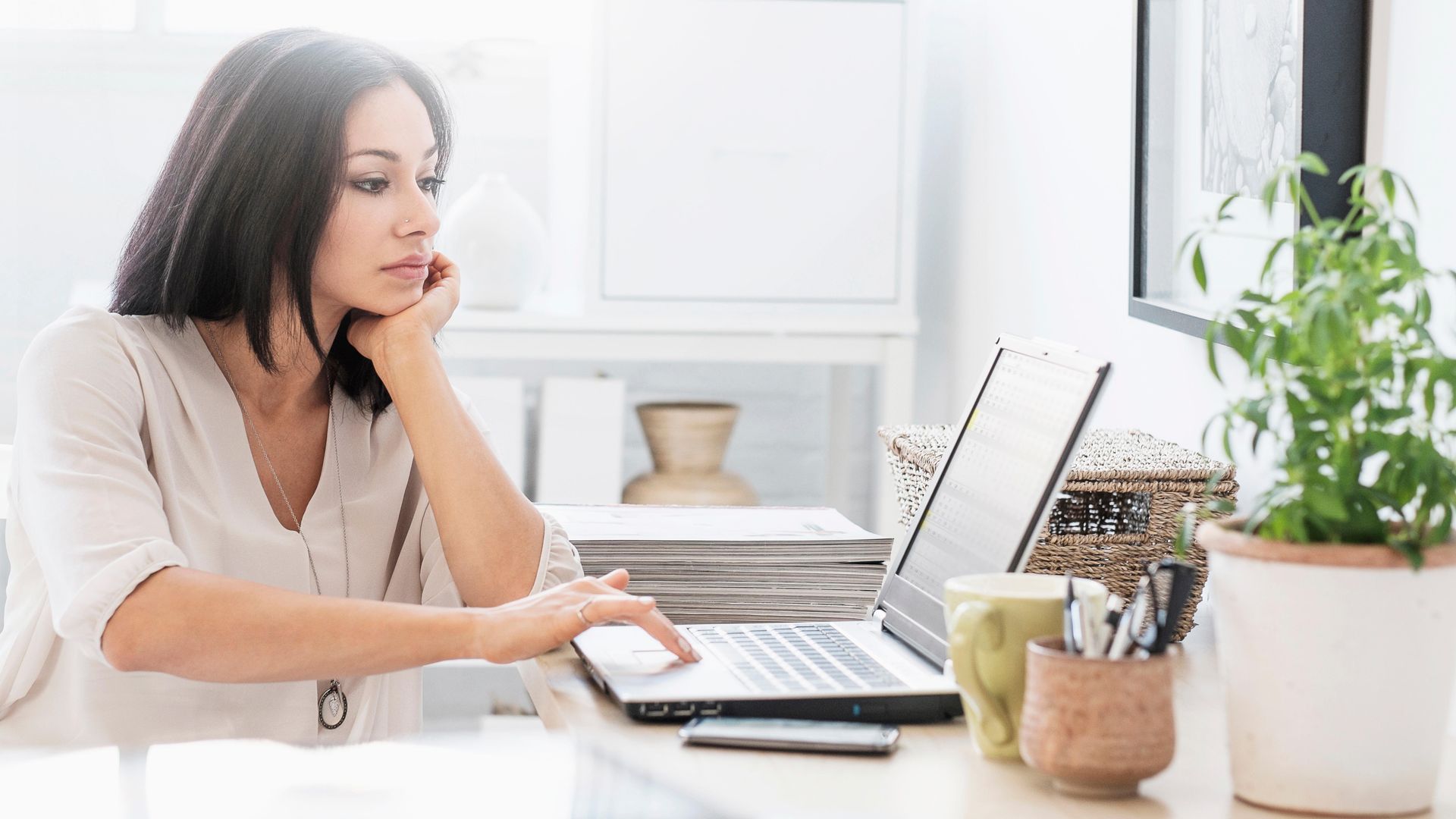Stock image of woman sitting at desk with laptop
