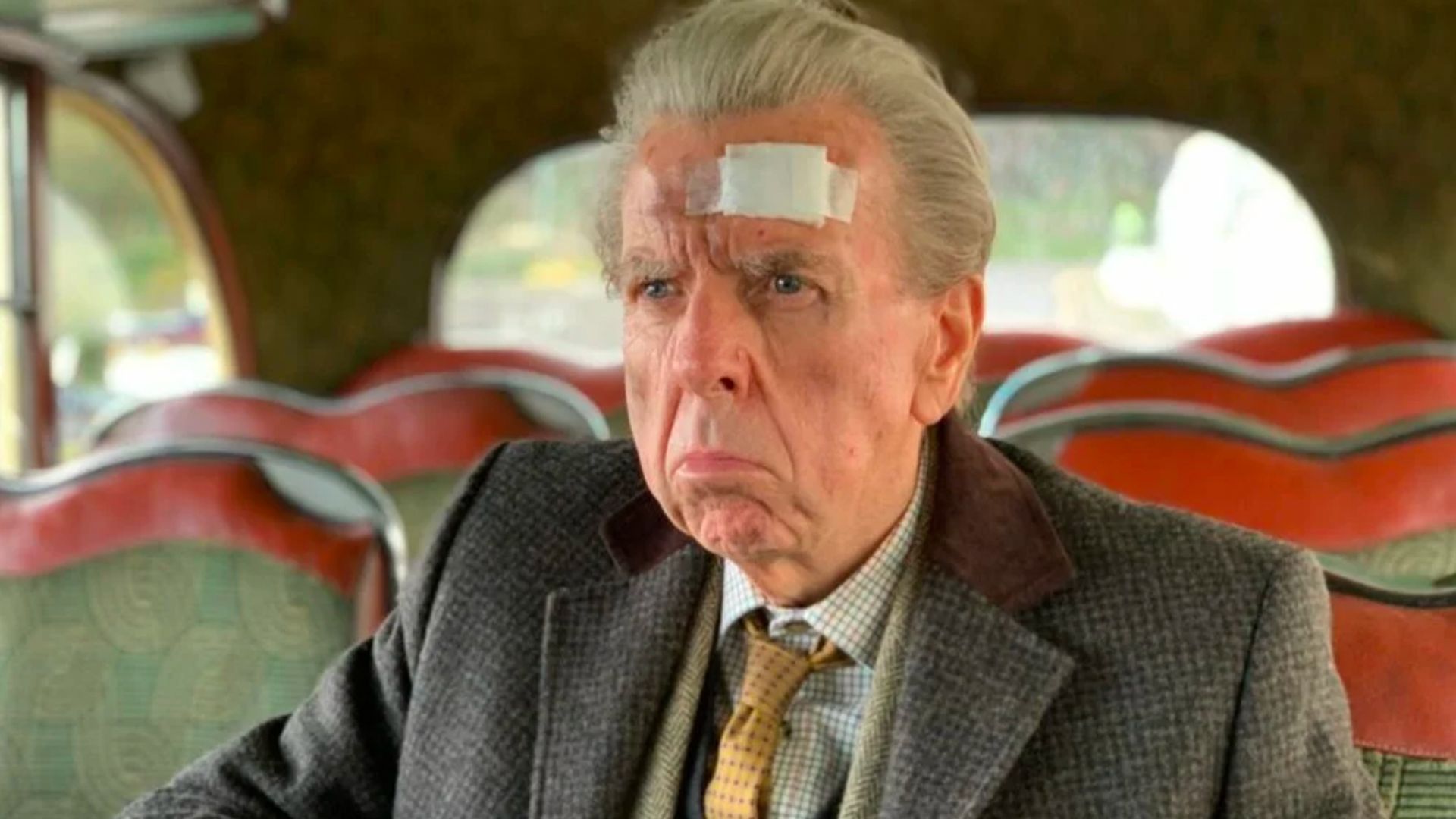 Timothy Spall in a bandage on his head in a still from The Last Bus