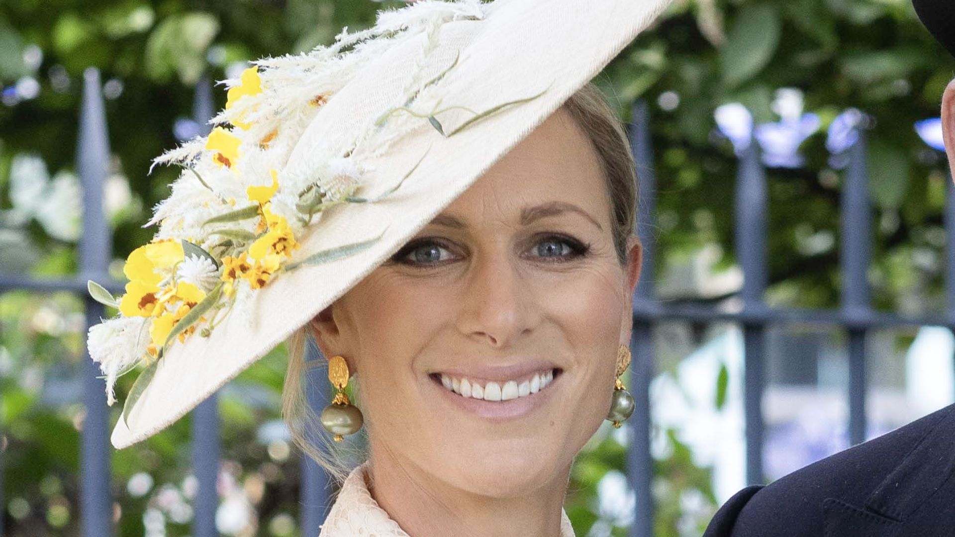Zara Tindall smiling in a floral hat