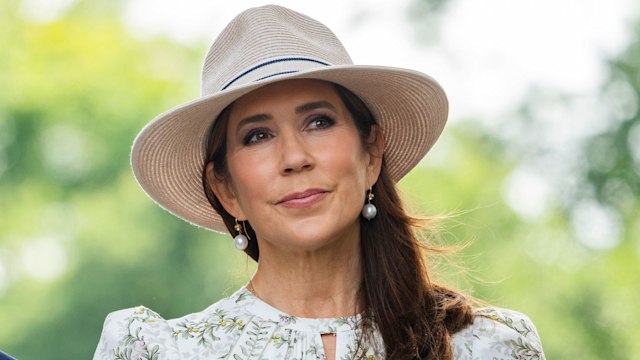 Queen Mary wearing hat and pearls