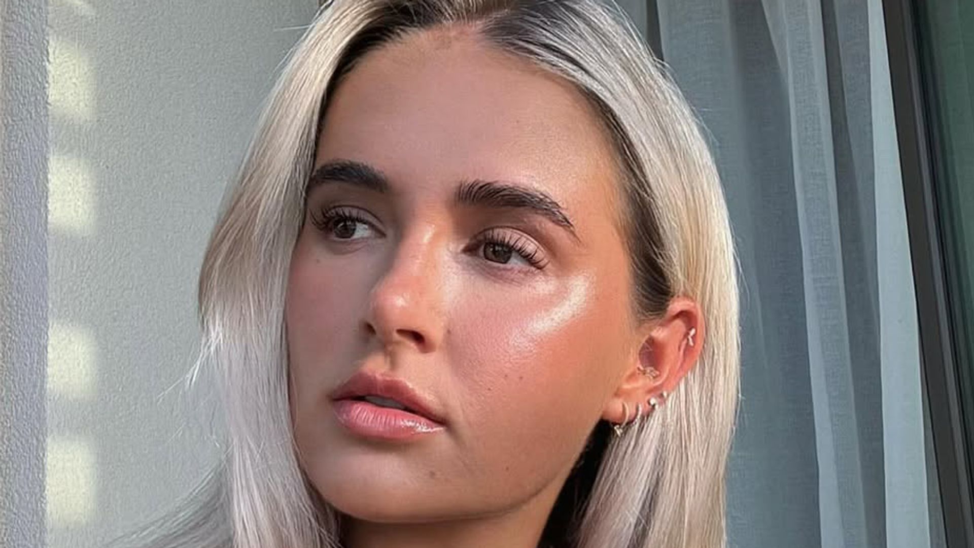 Molly Mae in brown top with glam skin