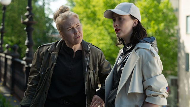 two women standing in street