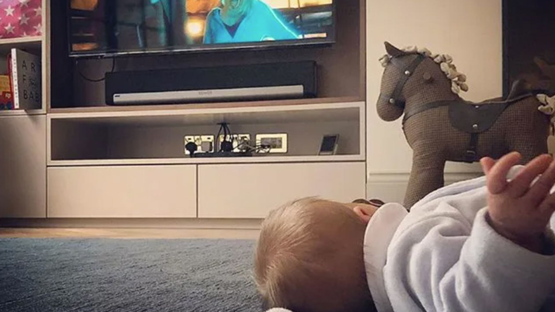 A young child watching a TV