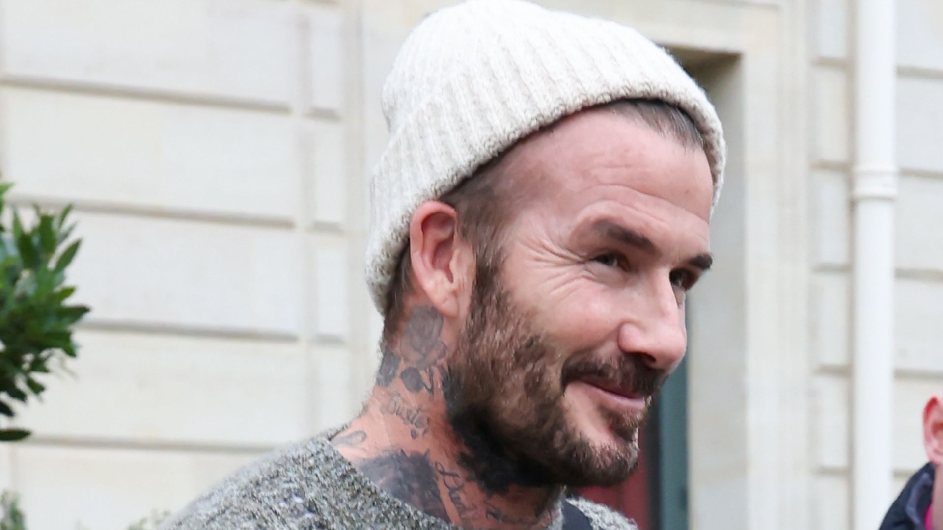 David Beckham on street in jumper and beanie