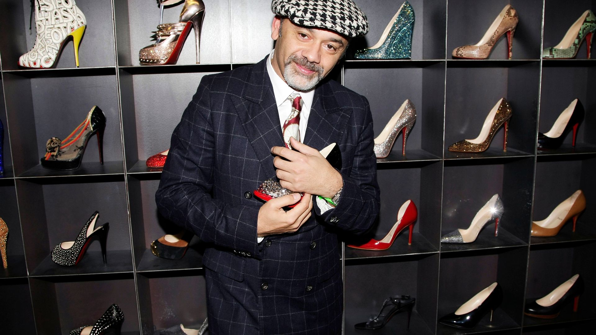 Christian Louboutin at one of his shoe shops