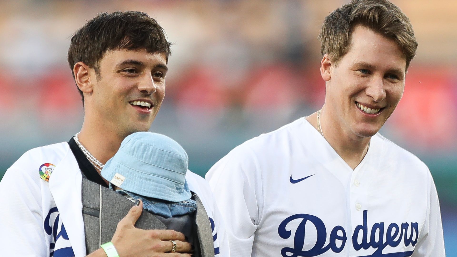 Tom Daley and Dustin Lance Black with their sons at a Dodgers game