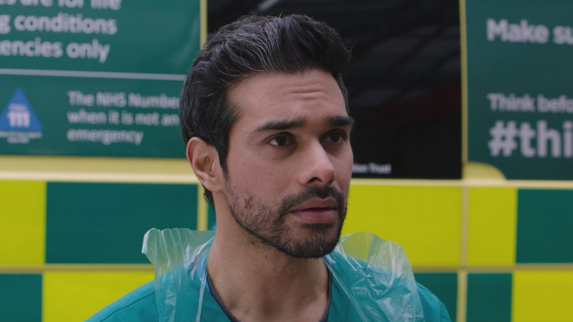Neet Mohan as Rash Masum in front of an ambulance in Casualty