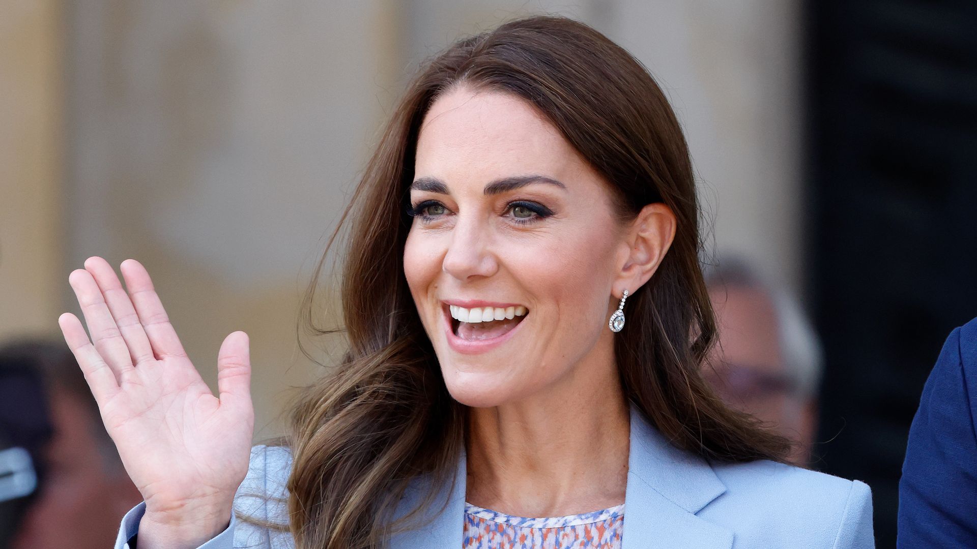 Kate Middleton waves wearing a blue coat