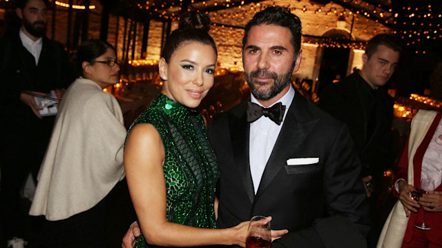 Eva Longoria and her husband Jose Baston posing at a formal dinner