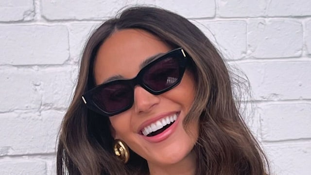 woman smiling in strapless top and sunglasses