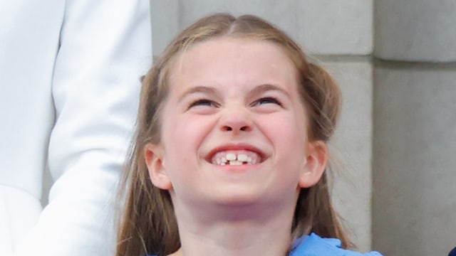 Princess Charlotte smiling in a blue dress