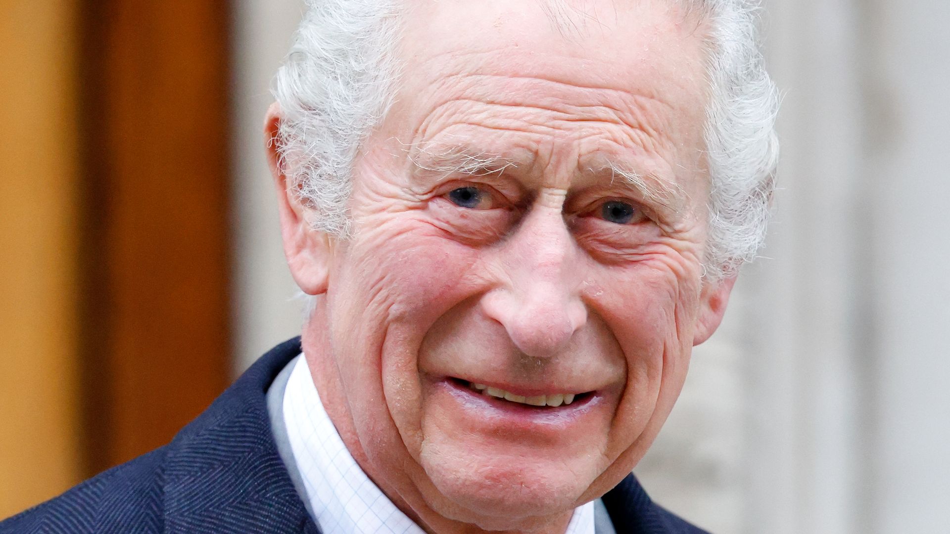 king charles smiling in navy suit